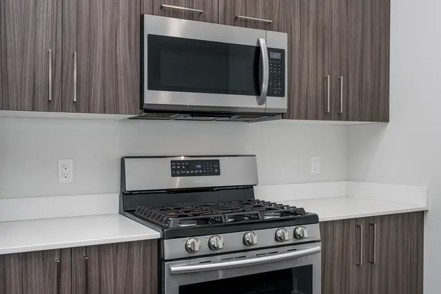 a stove top oven sitting inside of a kitchen