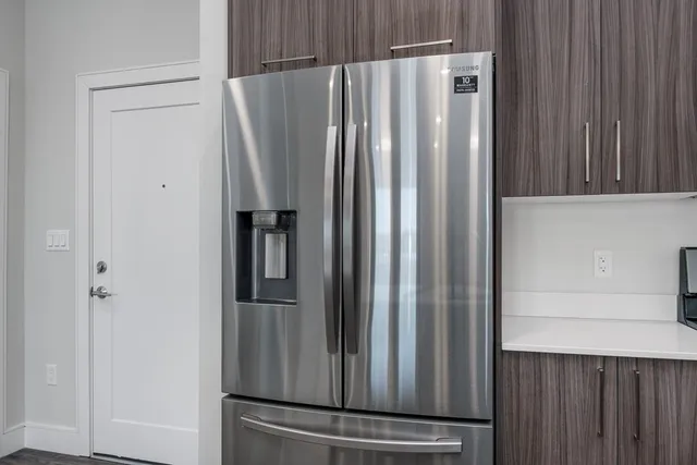 a view of kitchen with refrigerator and cabinet