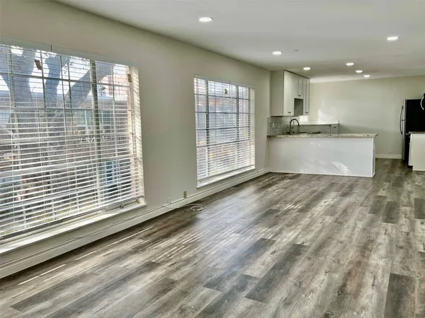 a view of kitchen with kitchen island sink and window