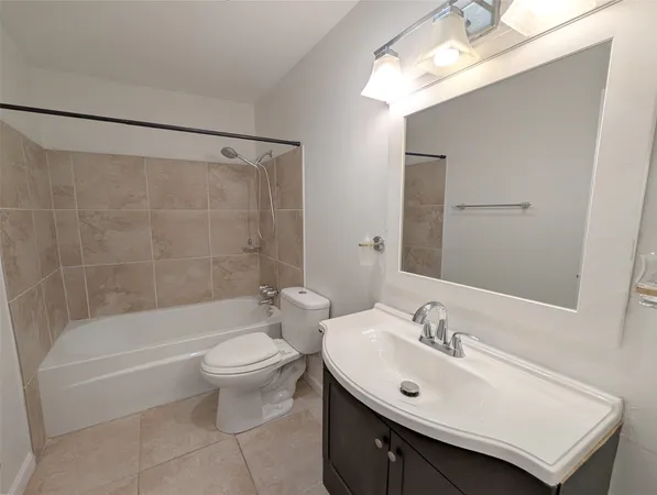 a view of a room with wooden floor and a ceiling fan