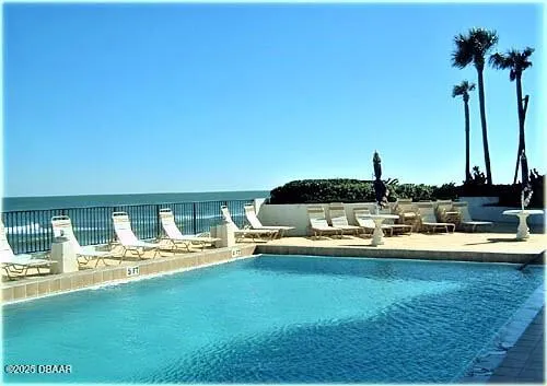 a view of swimming pool with outdoor seating