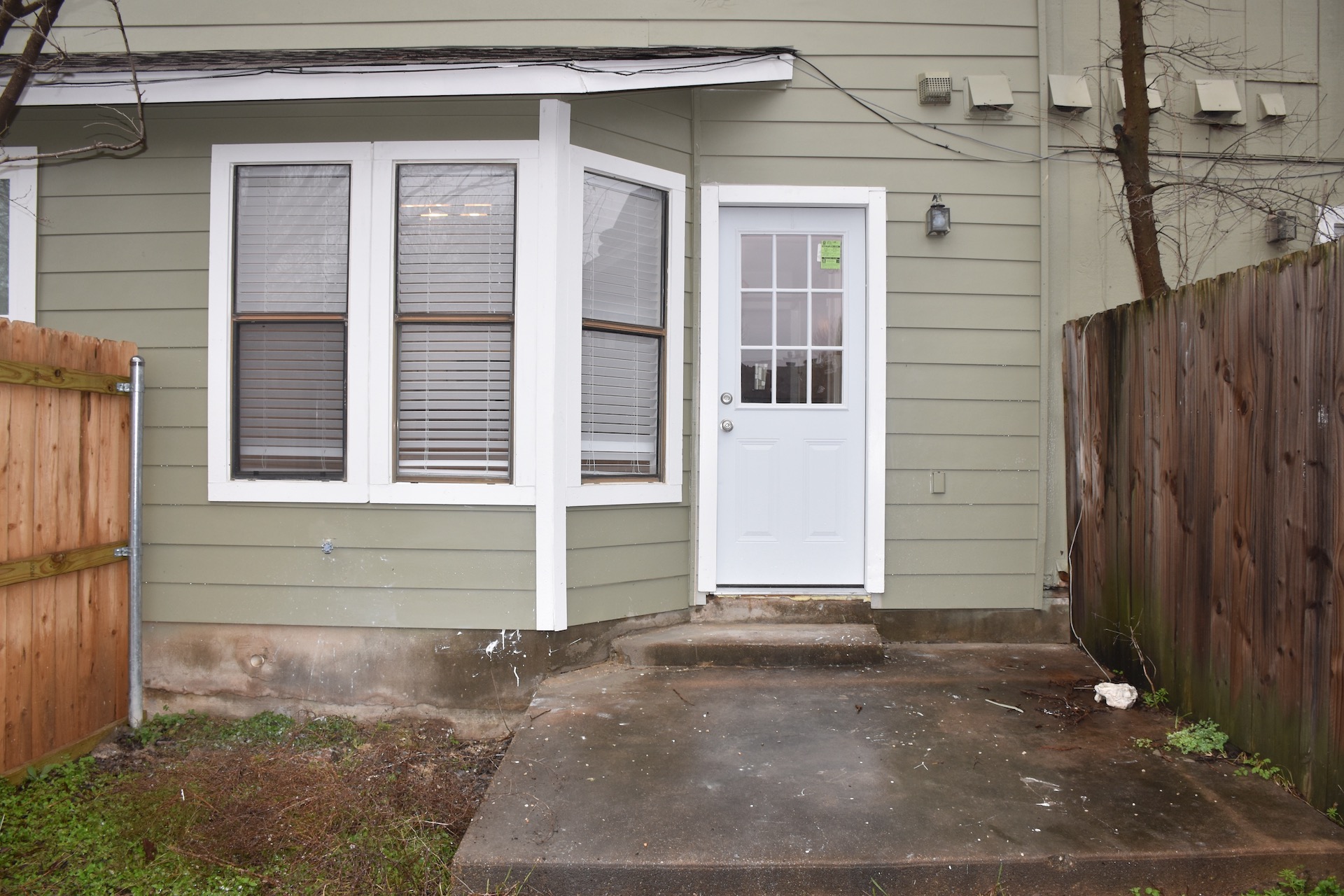 1810 Rawhide Loop Round Rock, TX 78681 - Photo 28 of 29 Rear exterior featuring light green horizontal siding and a white paneled door with divided lites