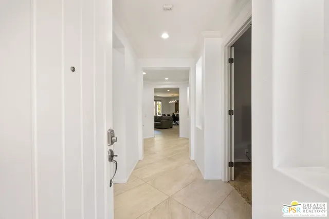 a living room with furniture a flat screen tv and kitchen view