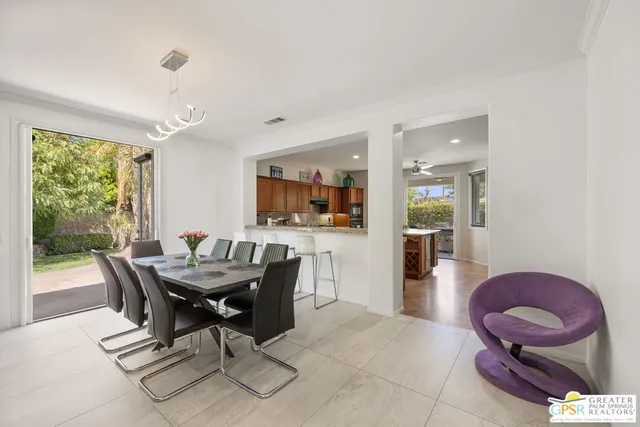 a open kitchen with white cabinets and stainless steel appliances