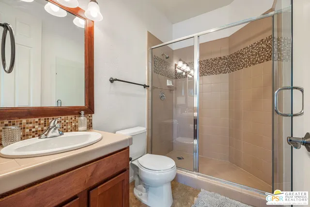 a bedroom with furniture and a flat screen tv