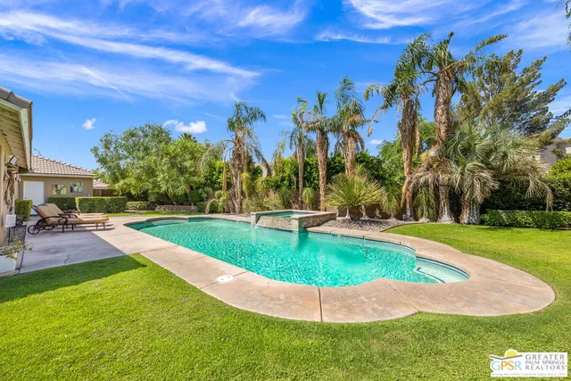 a view of a swimming pool with a yard