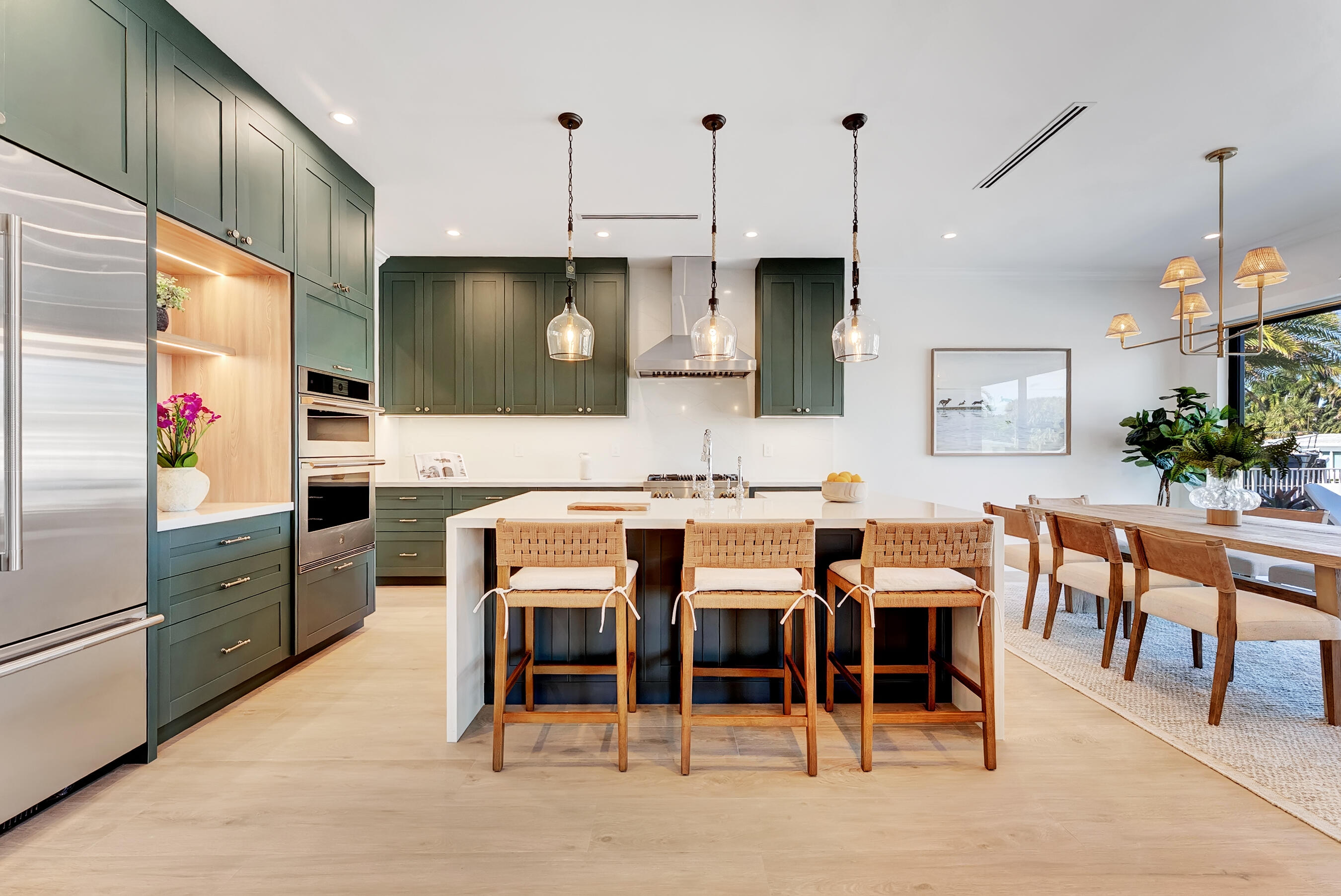 3205 Beacon Street Pompano Beach, FL 33062 - Photo 12 of 39 a kitchen with stainless steel appliances kitchen island granite countertop a table chairs sink and cabinets