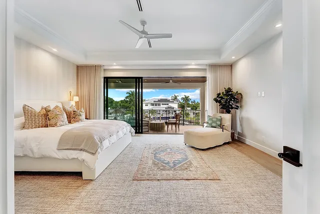 a spacious bedroom with a large bed and windows