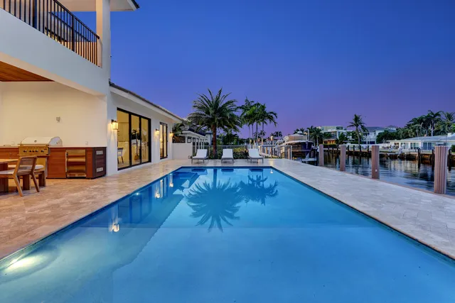 a view of a swimming pool with an outdoor seating