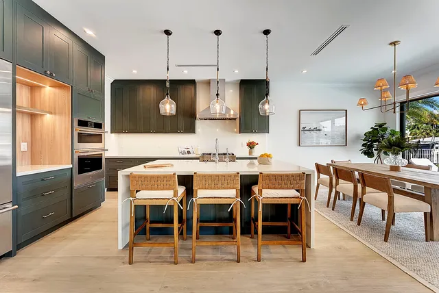 a kitchen with kitchen island stainless steel appliances a sink stove and refrigerator
