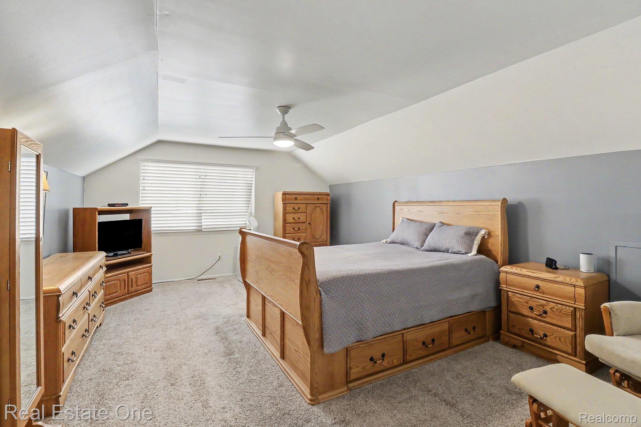 6570 Edgewood Road Canton, MI 48187 - Photo 12 of 22 Carpeted room featuring an angled ceiling, a window with blinds, and a ceiling fan