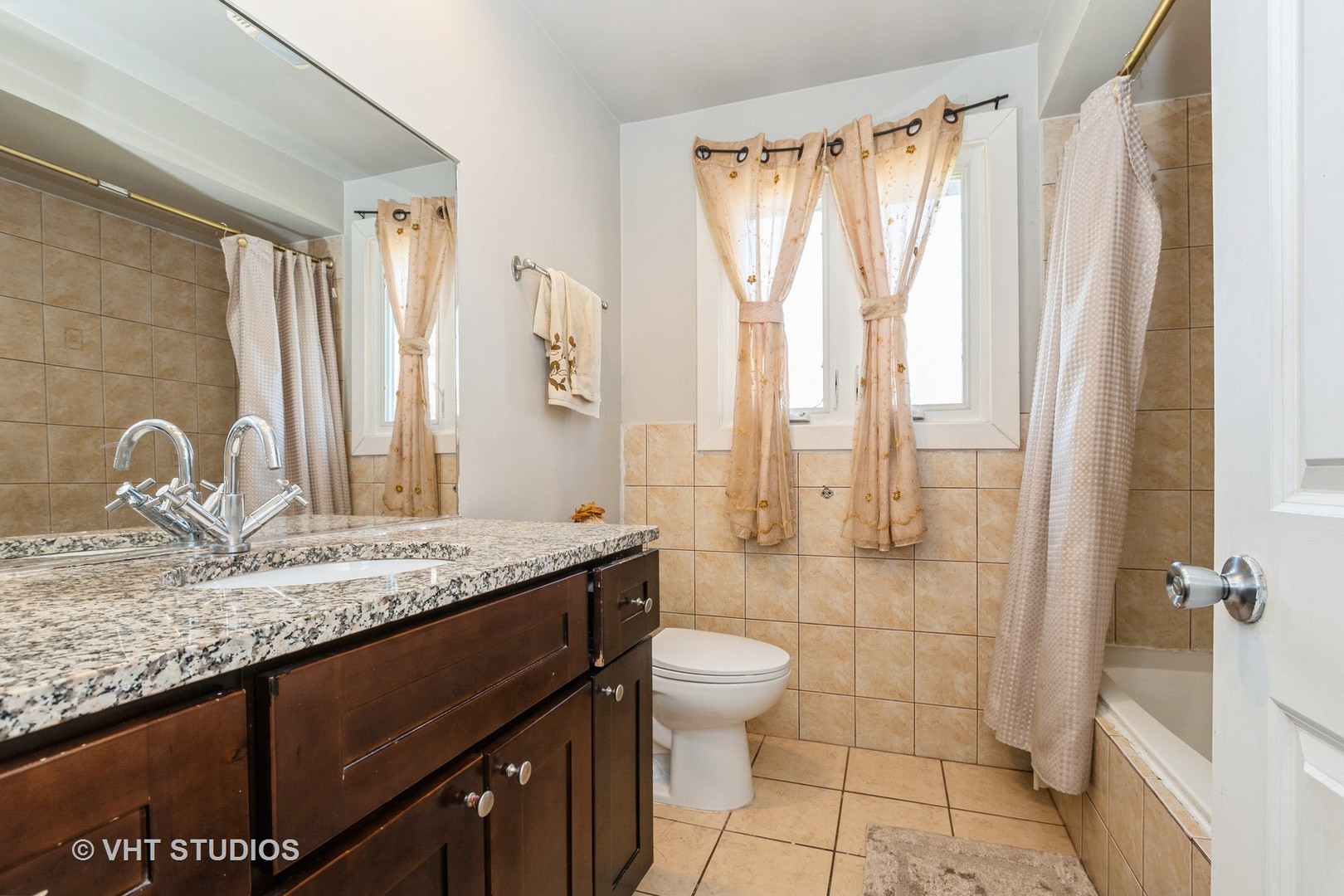 8036 Fawn Trail Justice, IL 60458 - Photo 12 of 16 a bathroom with a granite countertop sink a toilet and shower