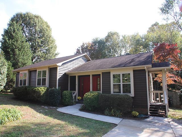 5408 Old Towne Road Raleigh, NC 27612 - Photo 1 of 18 a view of a house with a yard plants and large tree