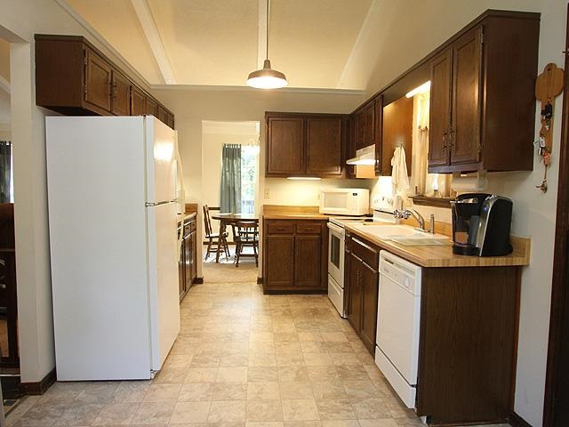 5408 Old Towne Road Raleigh, NC 27612 - Photo 6 of 18 a kitchen with stainless steel appliances a sink stove refrigerator and cabinets