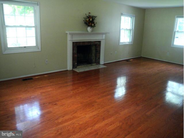 8908 Montpelier Drive Laurel, MD 20708 - Photo 10 of 23 Gleaming hardwood floors and fireplace.