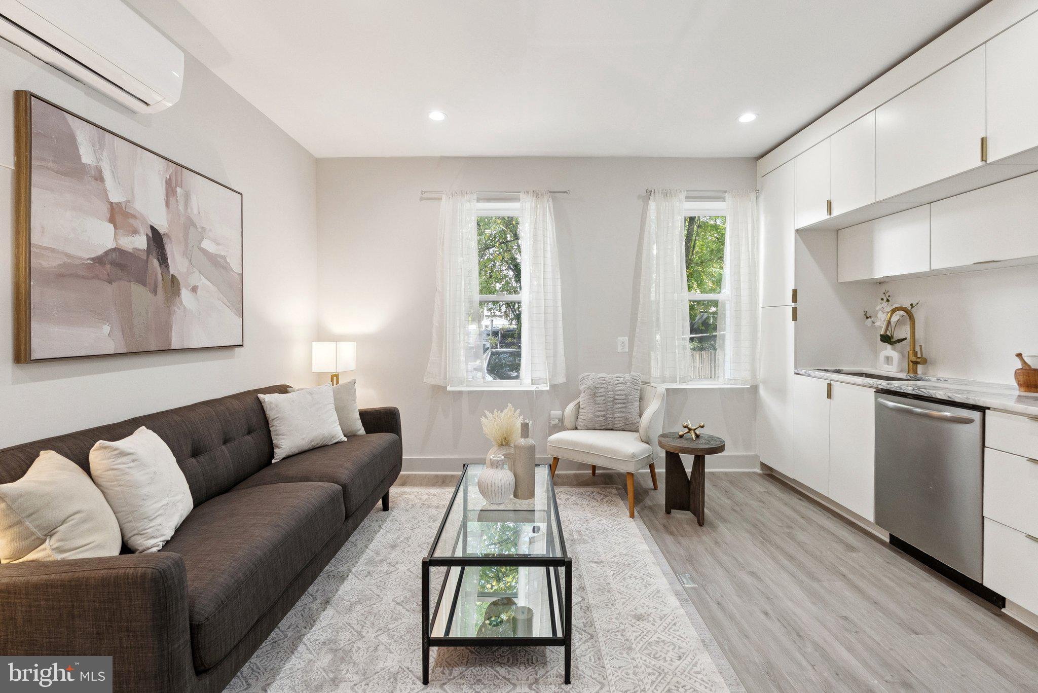 839 Kennedy Street Northwest, Unit 105 Washington, DC 20011 - Photo 1 of 21 a living room with furniture and a window