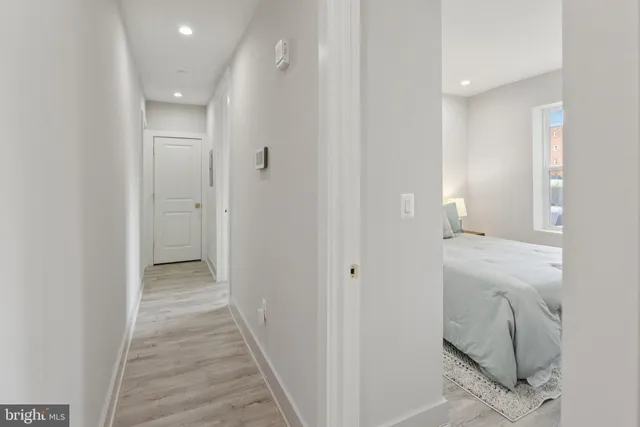 a view of a hallway with closet and wooden floor