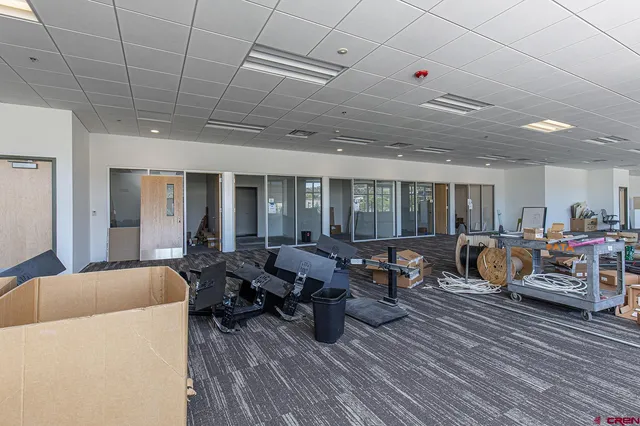 a living room with furniture floor to ceiling window and wooden floor