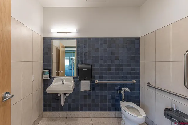 a hallway with wooden floor windows and chandelier