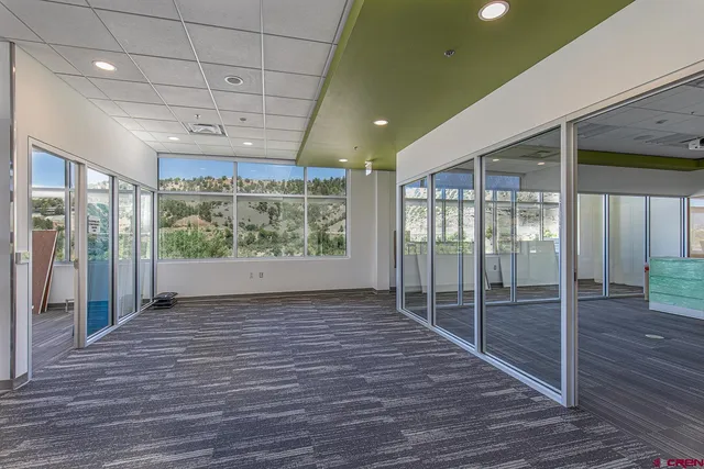 a view of hallway with livingroom and wooden floor