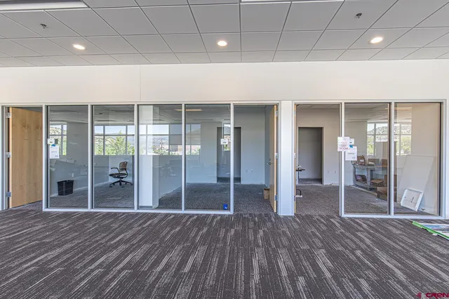 a view of a room with wooden floor and a window