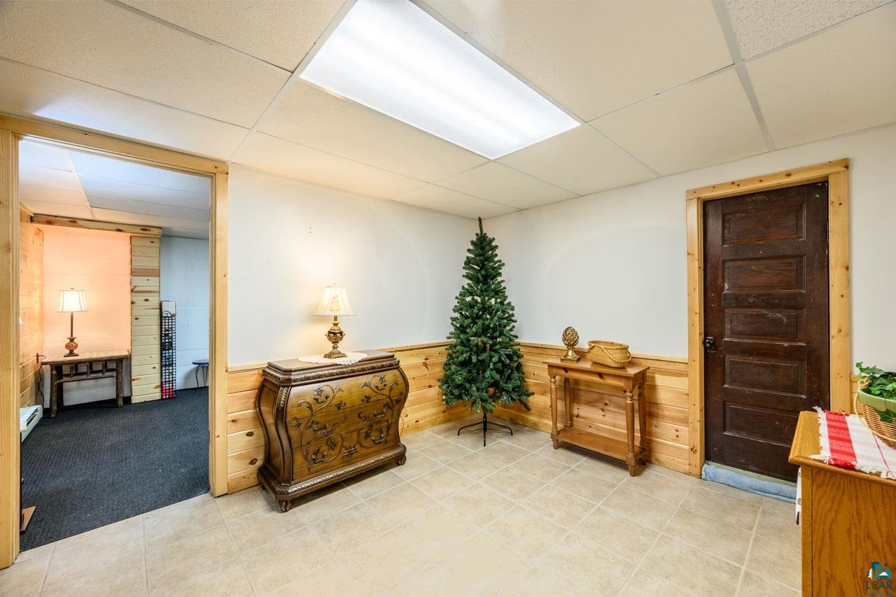 716 South 9th Street Virginia, MN 55792 - Photo 20 of 43 Tile flooring, wood paneling, drop ceiling, and wood-trim doorways