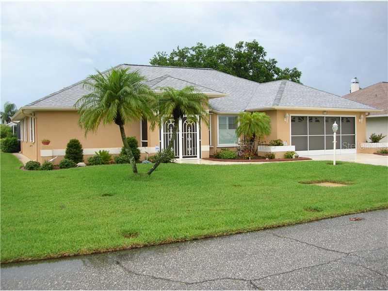 a front view of a house with a garden and plants