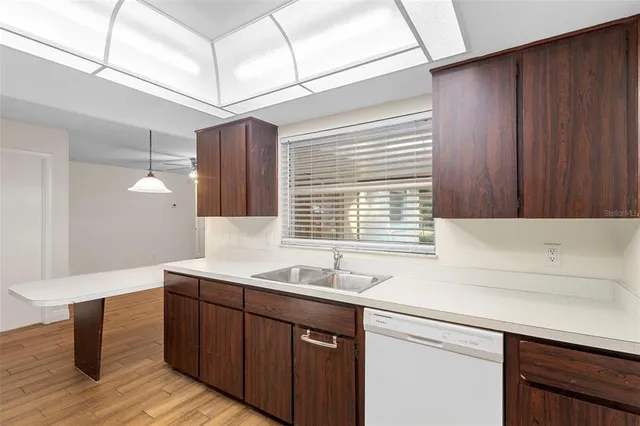 a kitchen with a sink and wooden cabinets