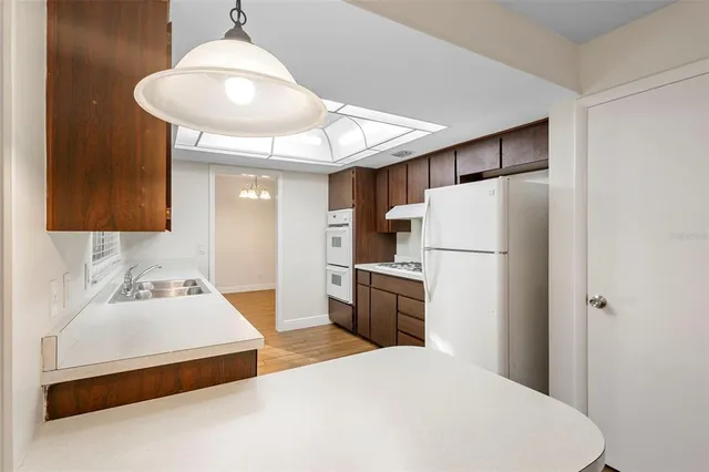 a bedroom with a bed and a refrigerator