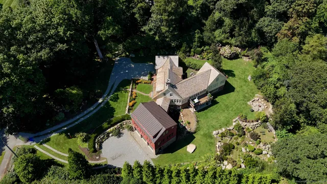 an aerial view of a house with garden space and street view