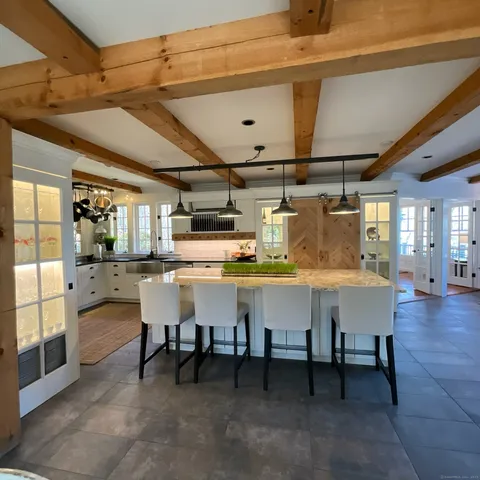 a kitchen with a table chairs and entryway