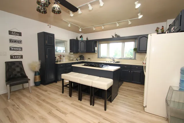 a large kitchen with a table and chairs
