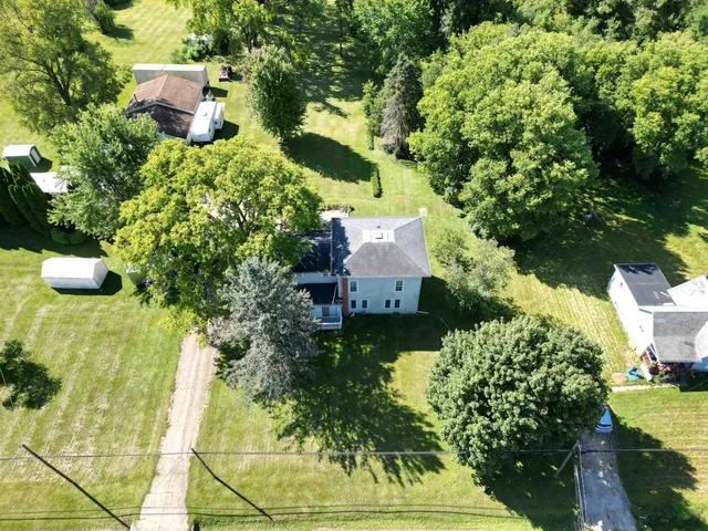 an aerial view of a house with a yard and garden