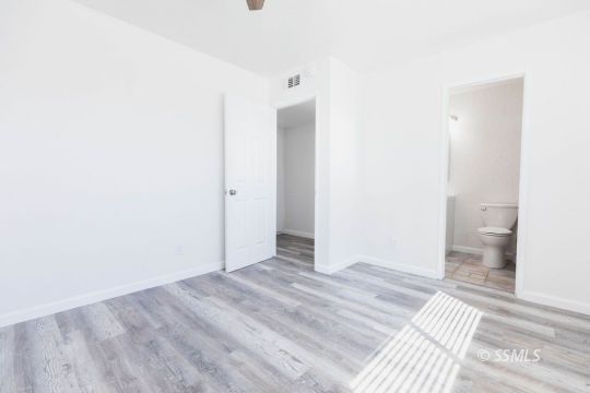 901 West Rader Avenue Ridgecrest, CA 93555 - Photo 13 of 26 a view of a room with wooden floor and a bathroom