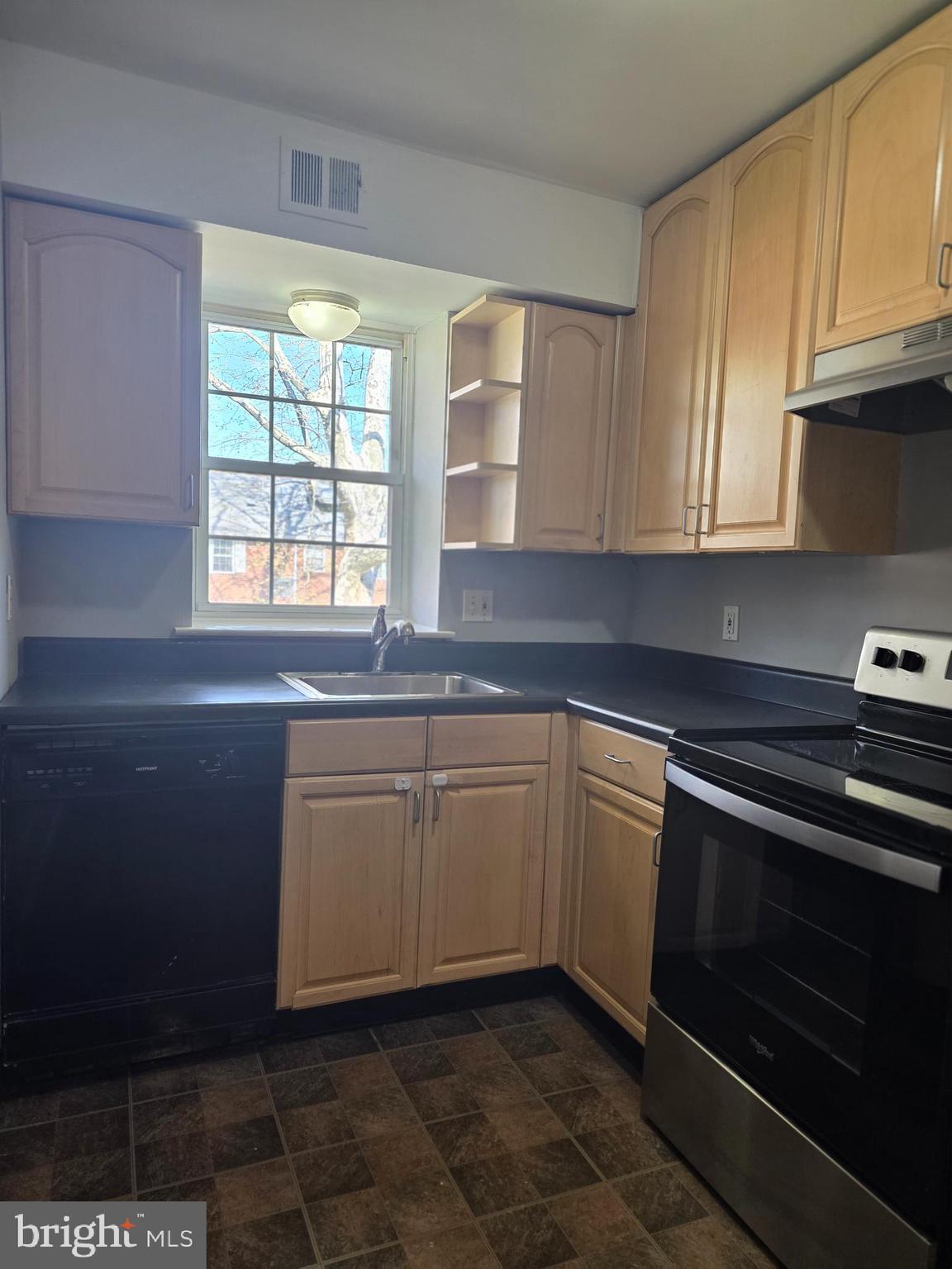 806 South Avenue, Unit E9 Secane, PA 19018 - Photo 11 of 17 a kitchen with granite countertop cabinets stainless steel appliances and a window