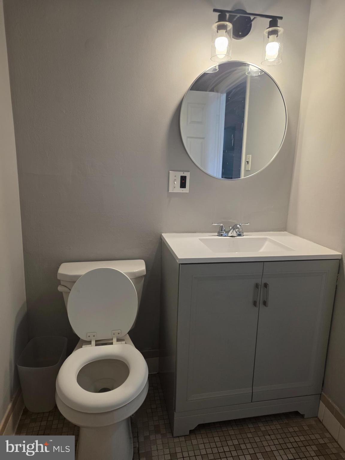 806 South Avenue, Unit E9 Secane, PA 19018 - Photo 13 of 17 a bathroom with a toilet sink and mirror