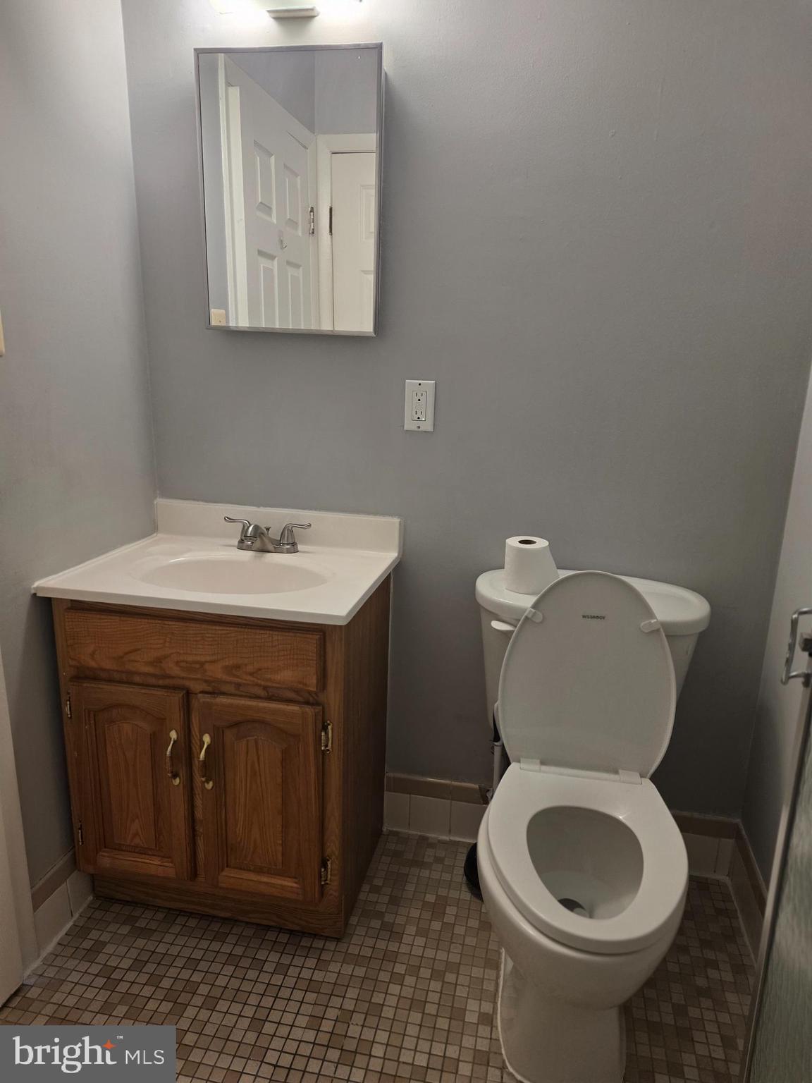 806 South Avenue, Unit E9 Secane, PA 19018 - Photo 16 of 17 a bathroom with a toilet sink and mirror