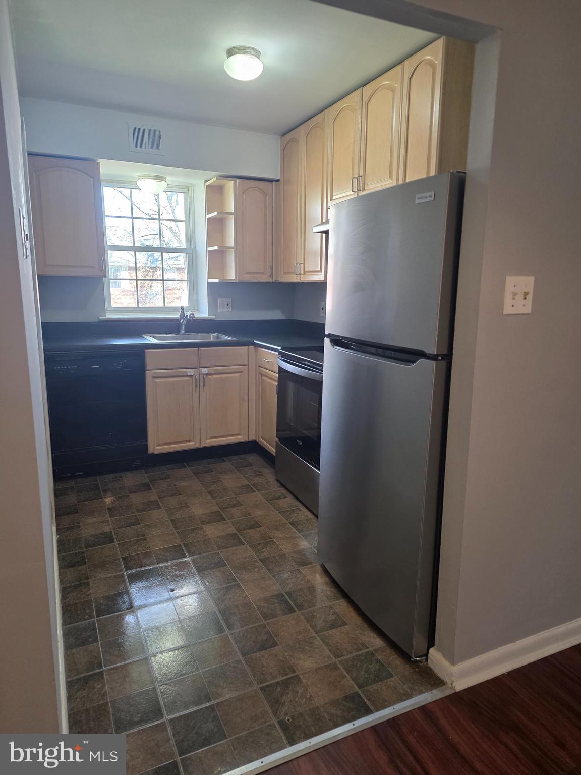 806 South Avenue, Unit E9 Secane, PA 19018 - Photo 10 of 17 a kitchen with a refrigerator a microwave and cabinets
