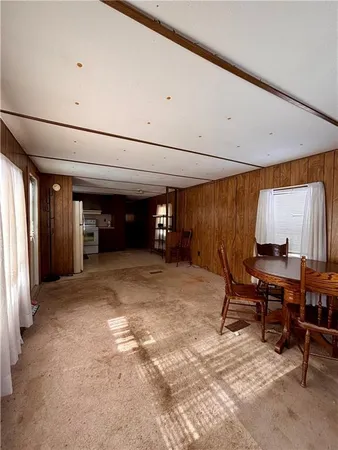 a kitchen with refrigerator and cabinets