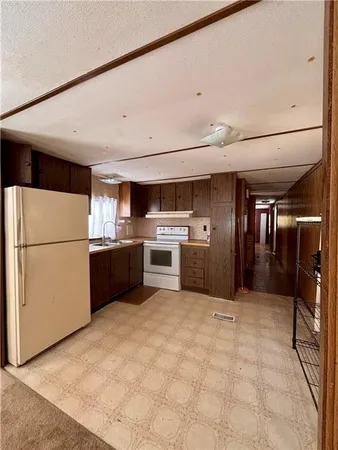 a view of kitchen with refrigerator and car parked
