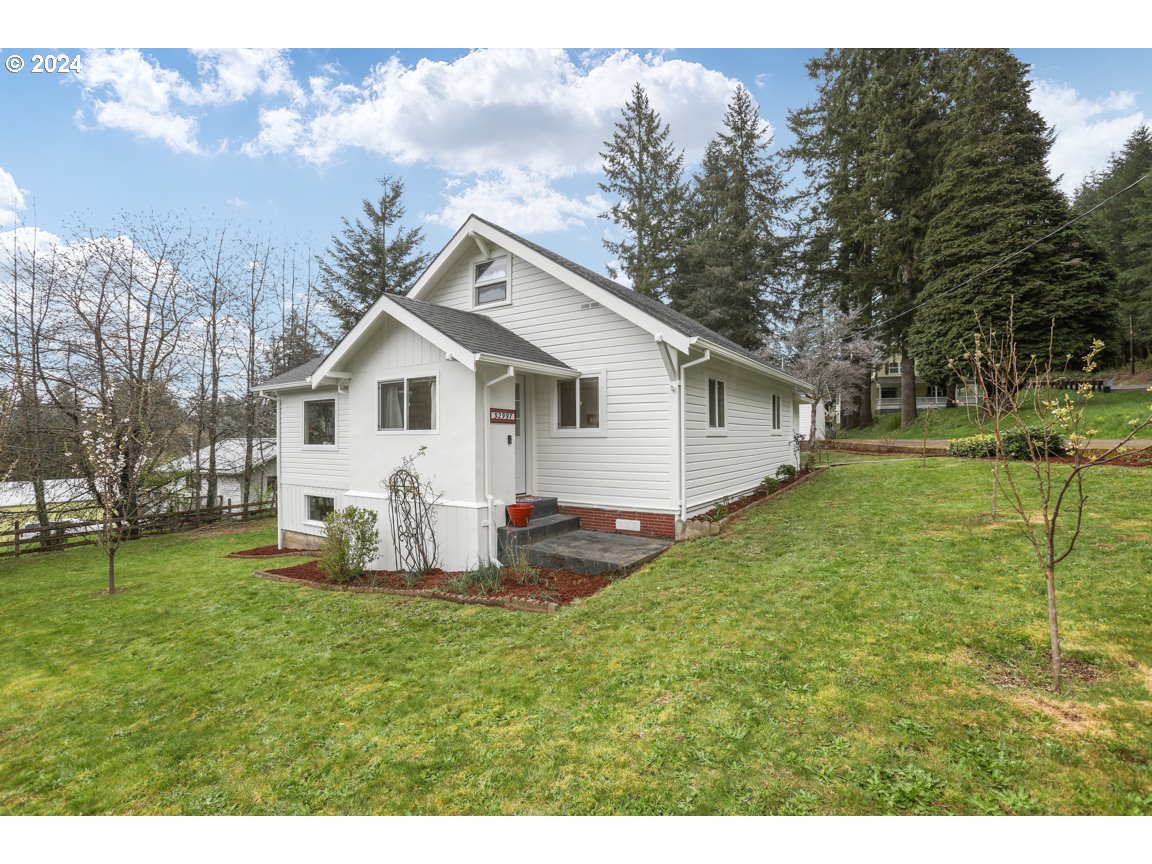 a backyard of a house with table and chairs