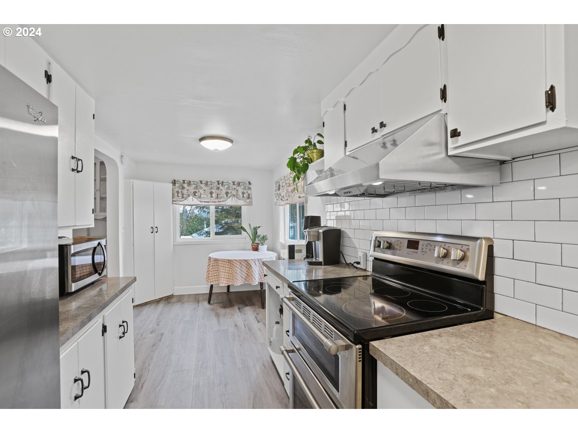 32997 Sykes Road St. Helens, OR 97051 - Photo 15 of 44 a kitchen with kitchen island a sink stove and refrigerator