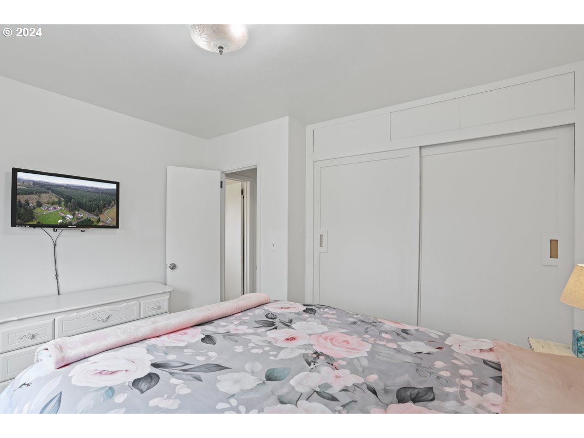 32997 Sykes Road St. Helens, OR 97051 - Photo 18 of 44 a bedroom with a bed and a flat screen tv