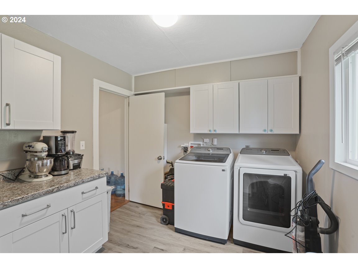 32997 Sykes Road St. Helens, OR 97051 - Photo 23 of 44 a kitchen with a stove top oven and cabinets