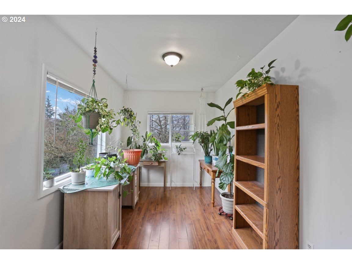32997 Sykes Road St. Helens, OR 97051 - Photo 8 of 44 a room with lots of potted plants and wooden floor