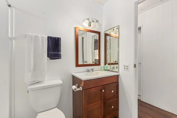 a bathroom with a toilet sink and mirror