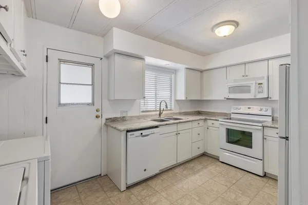 a kitchen with a sink stove and cabinets