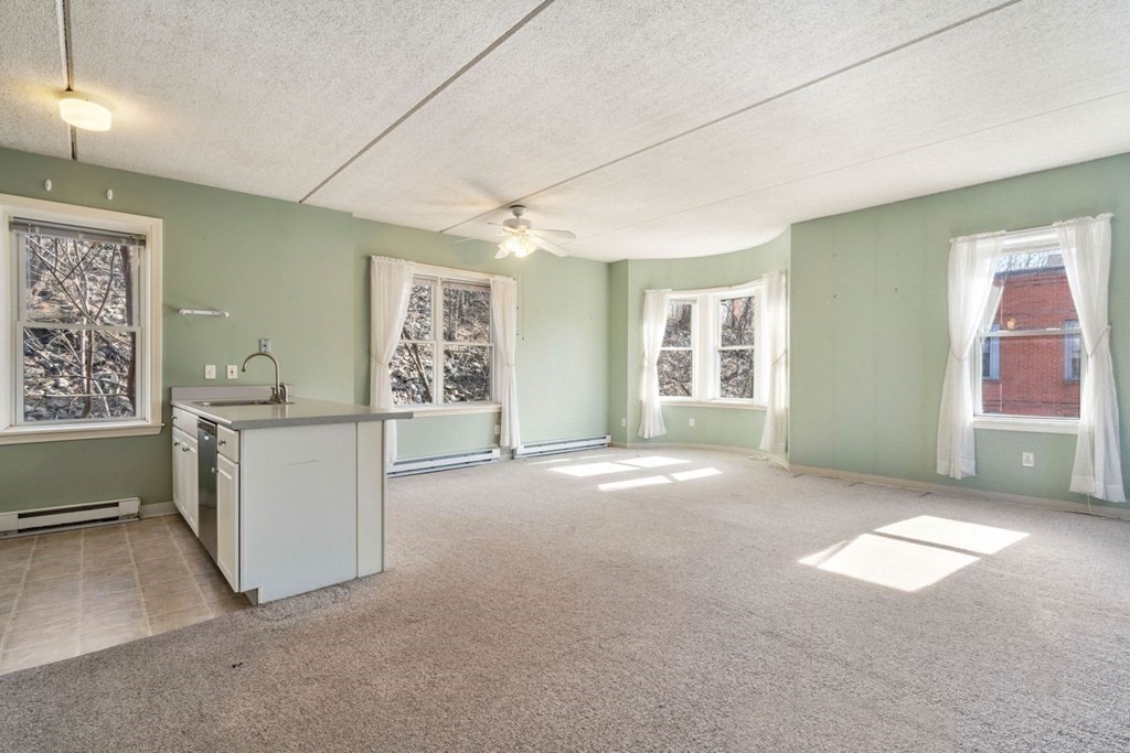 5 B Eileen Circle, Unit 11 Boston, MA 02130 - Photo 3 of 19 a view of a big room with windows and chandelier fan