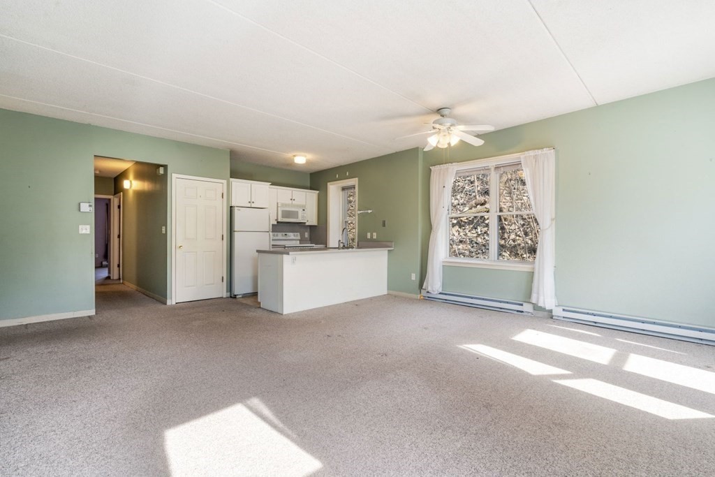 5 B Eileen Circle, Unit 11 Boston, MA 02130 - Photo 7 of 19 a view of a kitchen with a refrigerator a microwave and a sink