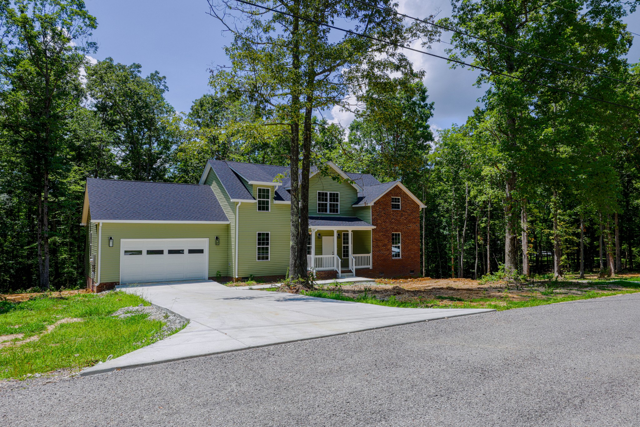 161 Vista Pointe Hohenwald, TN 38462 - Photo 2 of 43 a front view of a house with a yard and garage